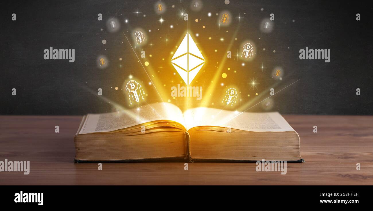 Open book with currency icons above Stock Photo - Alamy