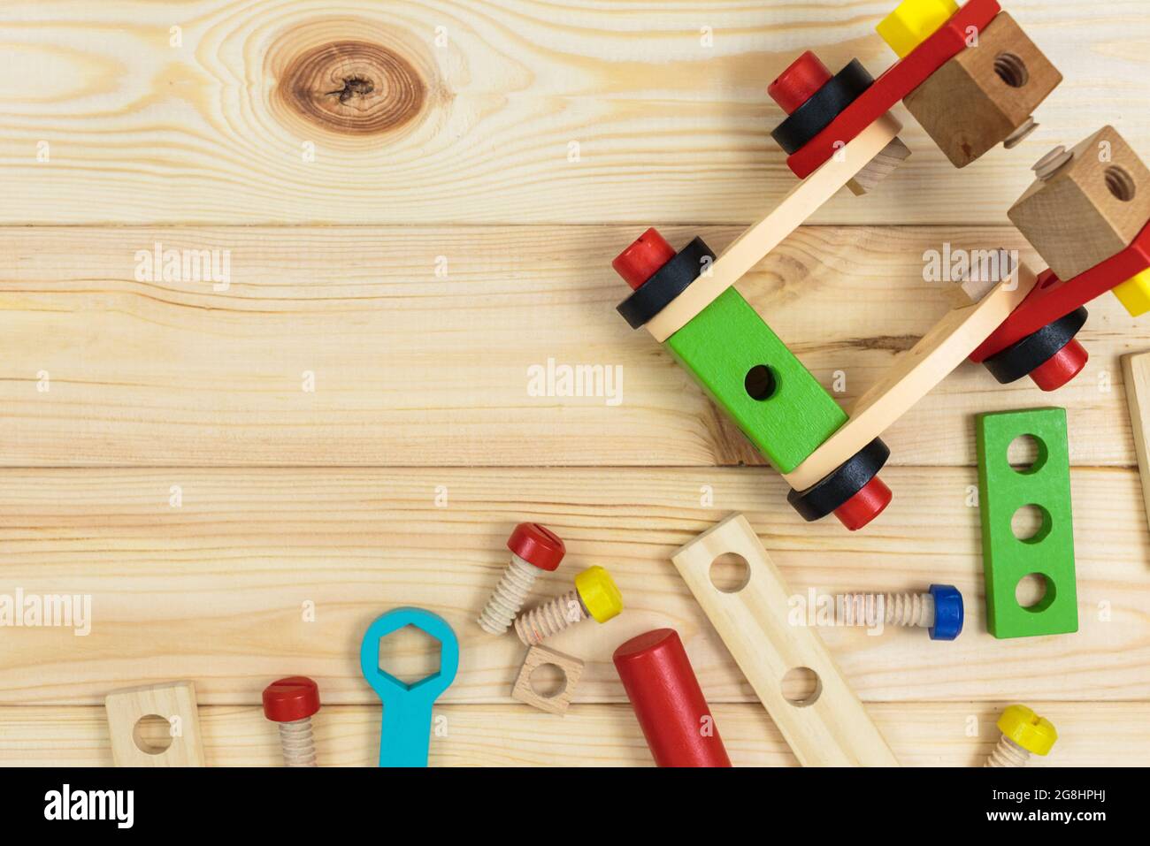 A colorful wooden building kit for children on wood. Set of tools on