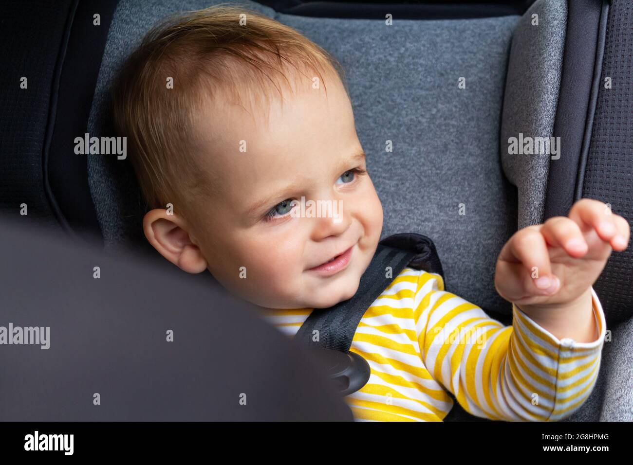 Baby in car seat goodbye before leaving. Stock Photo