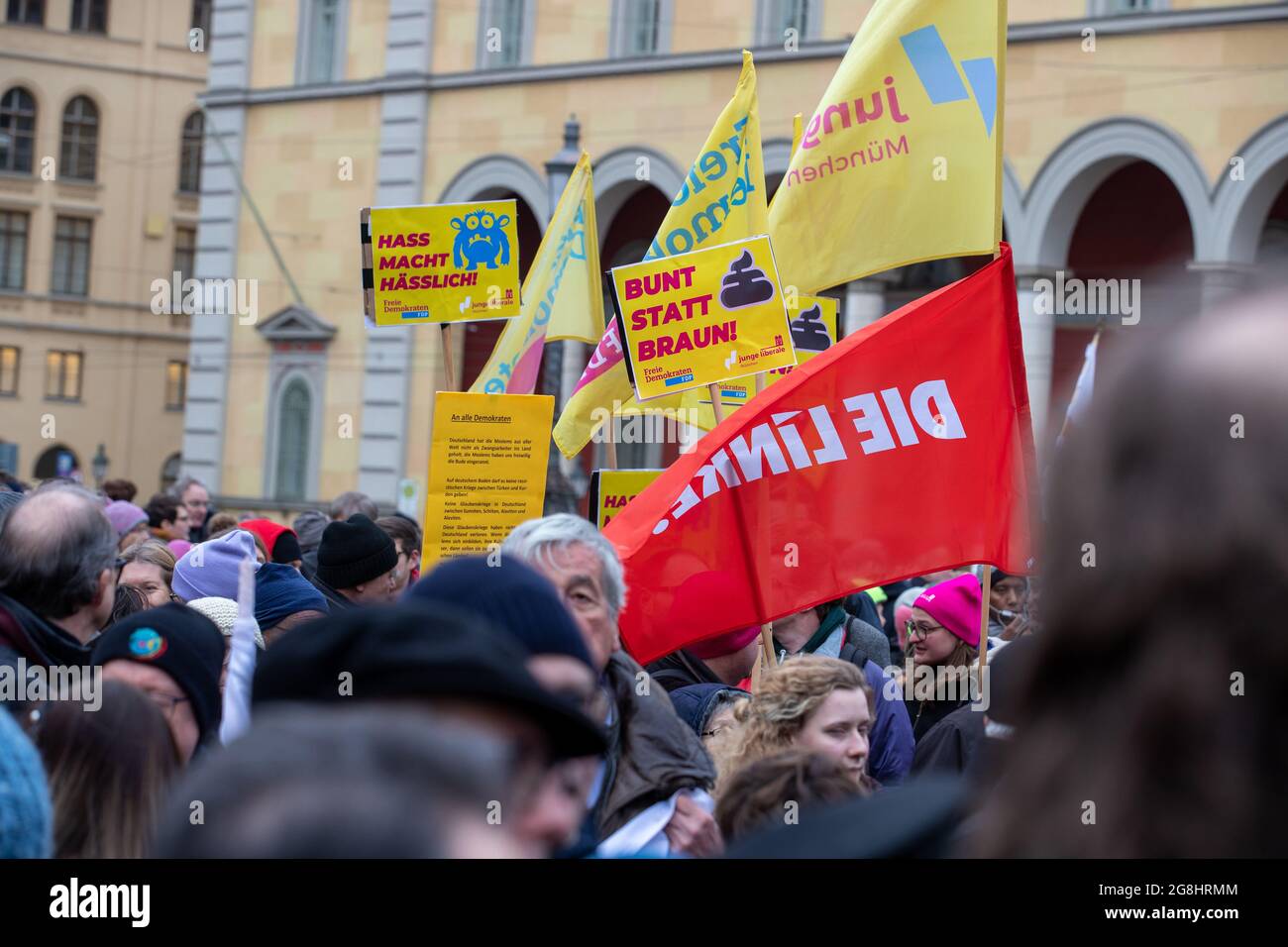 Munich, Germany. 06th Mar, 2020. A flag of Die Linke in front of some signs of the FDP reading ' Hate makes ugly ' and ' Colorful instead of brown! ' at the antifascist protest ' Just don't do it ' organized by Bellevue di Monaco on 6. March 2020 at the Max-Josef-Platz in Munich. (Photo by Alexander Pohl/Sipa USA) Credit: Sipa USA/Alamy Live News Stock Photo