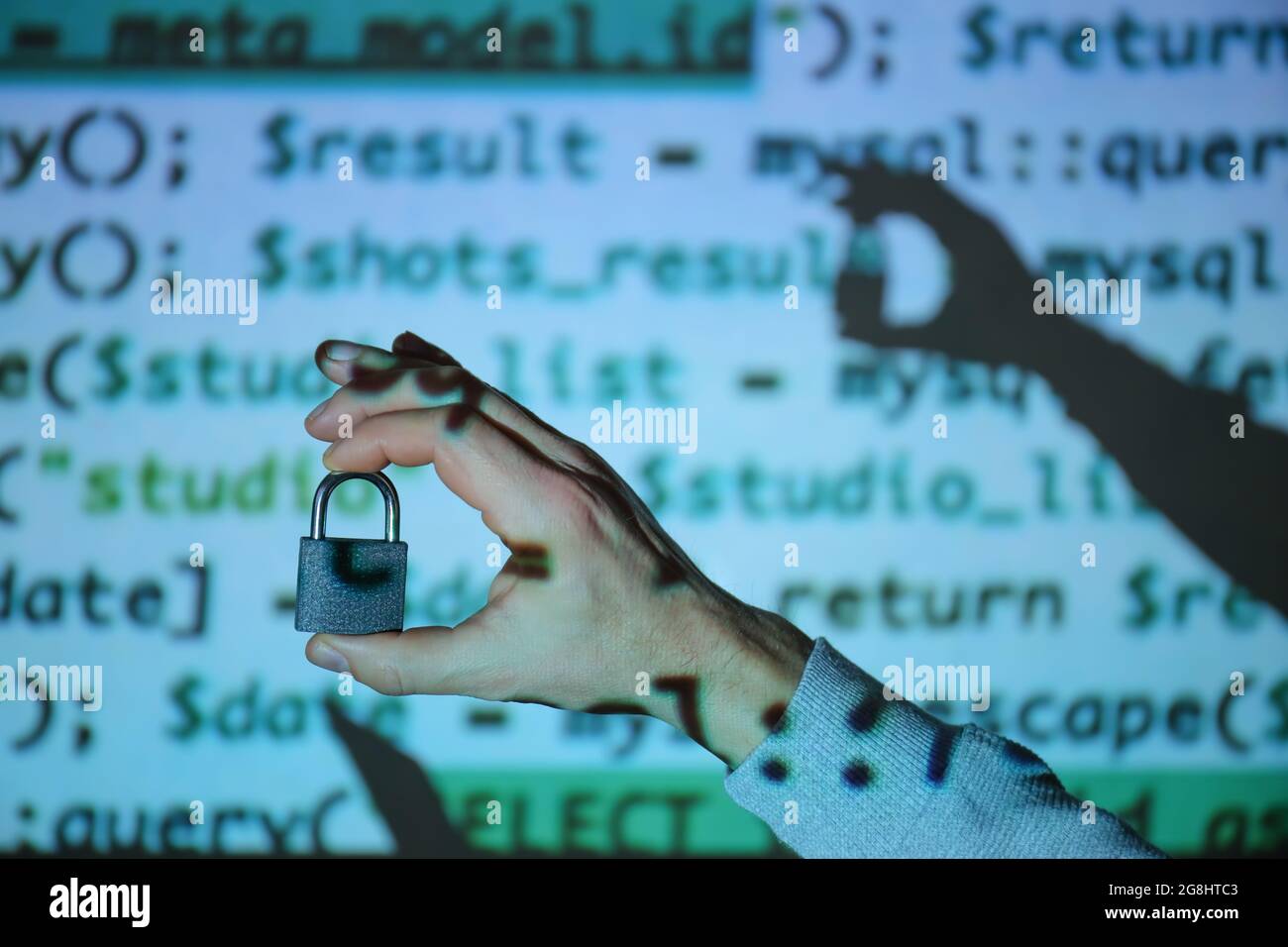 Hand of hacker with padlock near screen of computer Stock Photo - Alamy