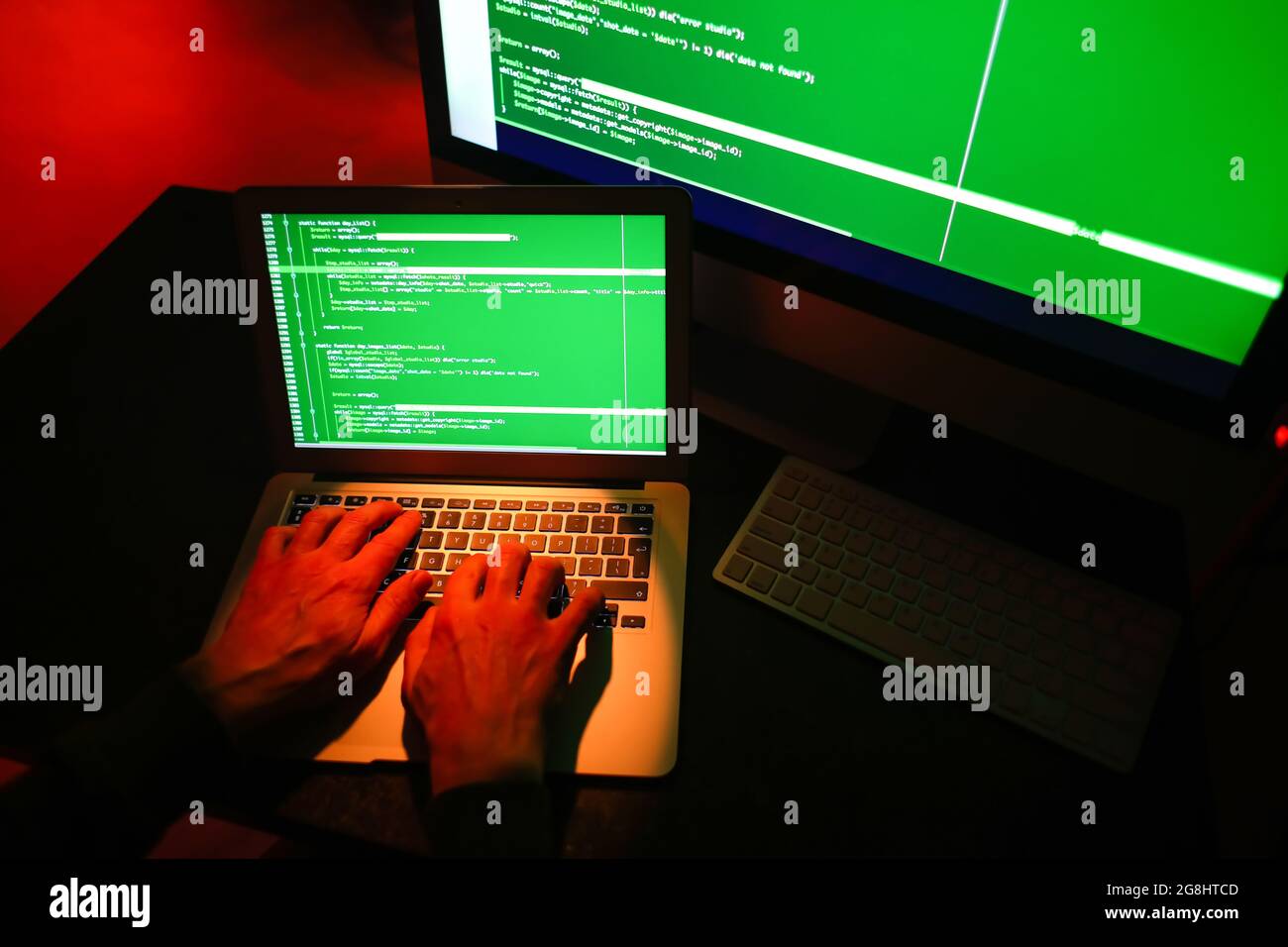 Hacker using computer in dark room Stock Photo - Alamy