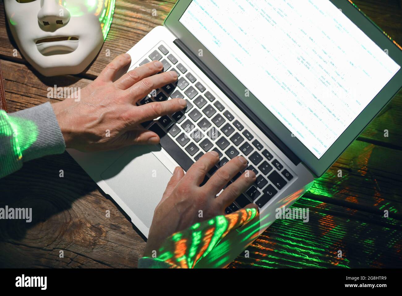 Hacker using computer in dark room Stock Photo - Alamy