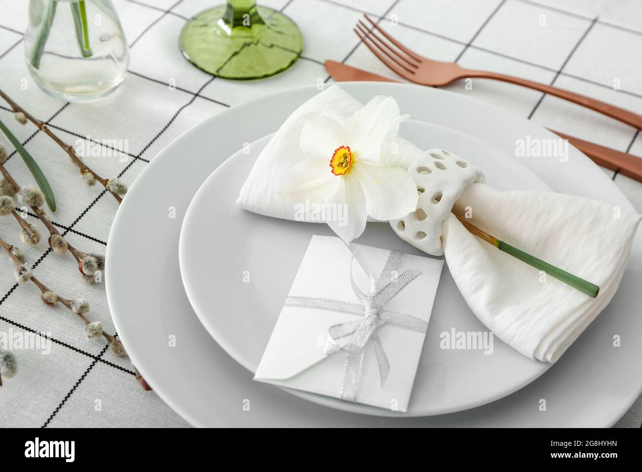 Beautiful table setting with narcissus flower Stock Photo