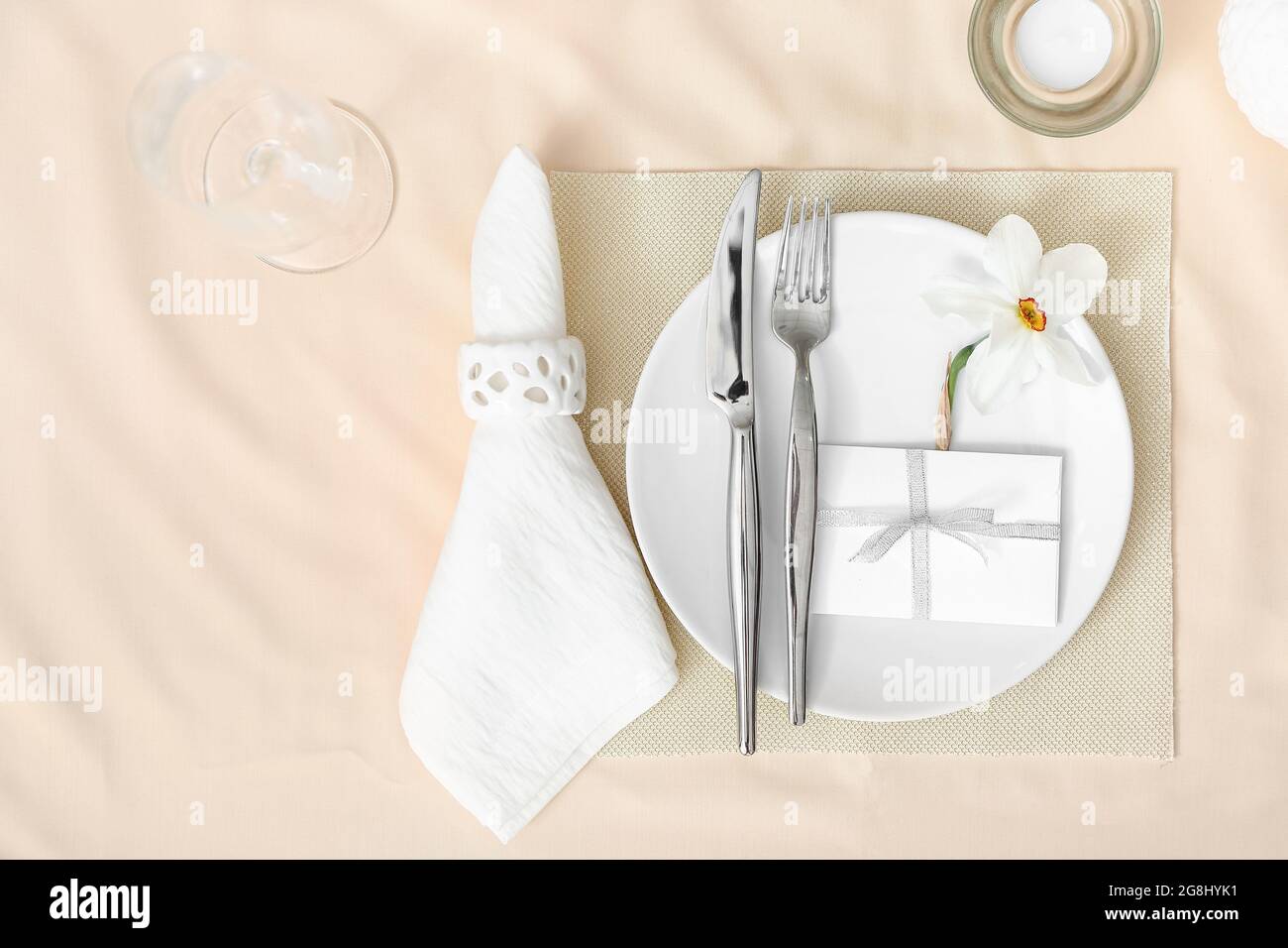 Beautiful table setting with narcissus flower Stock Photo