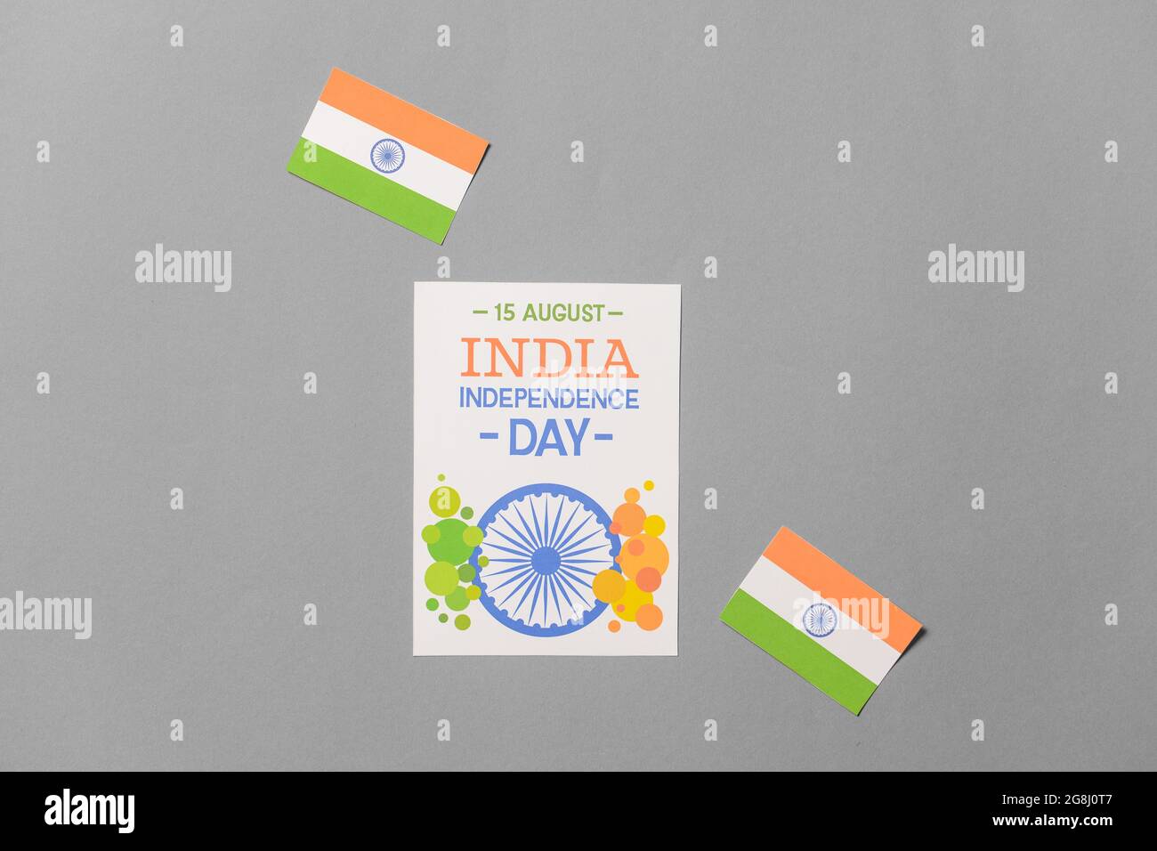 Indian flags and greeting card for Independence Day on grey background ...