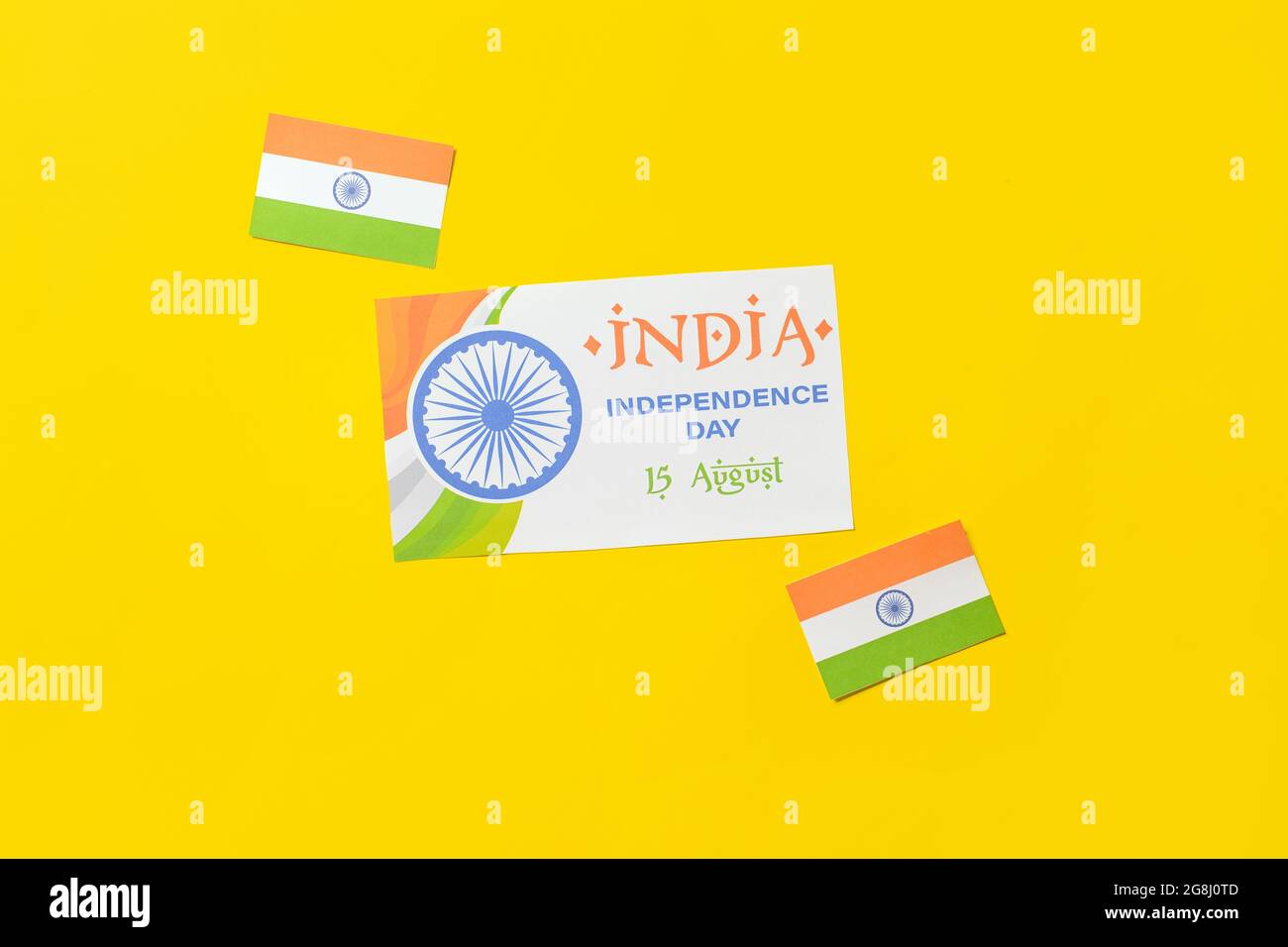 Indian flags and greeting card for Independence Day on color background ...