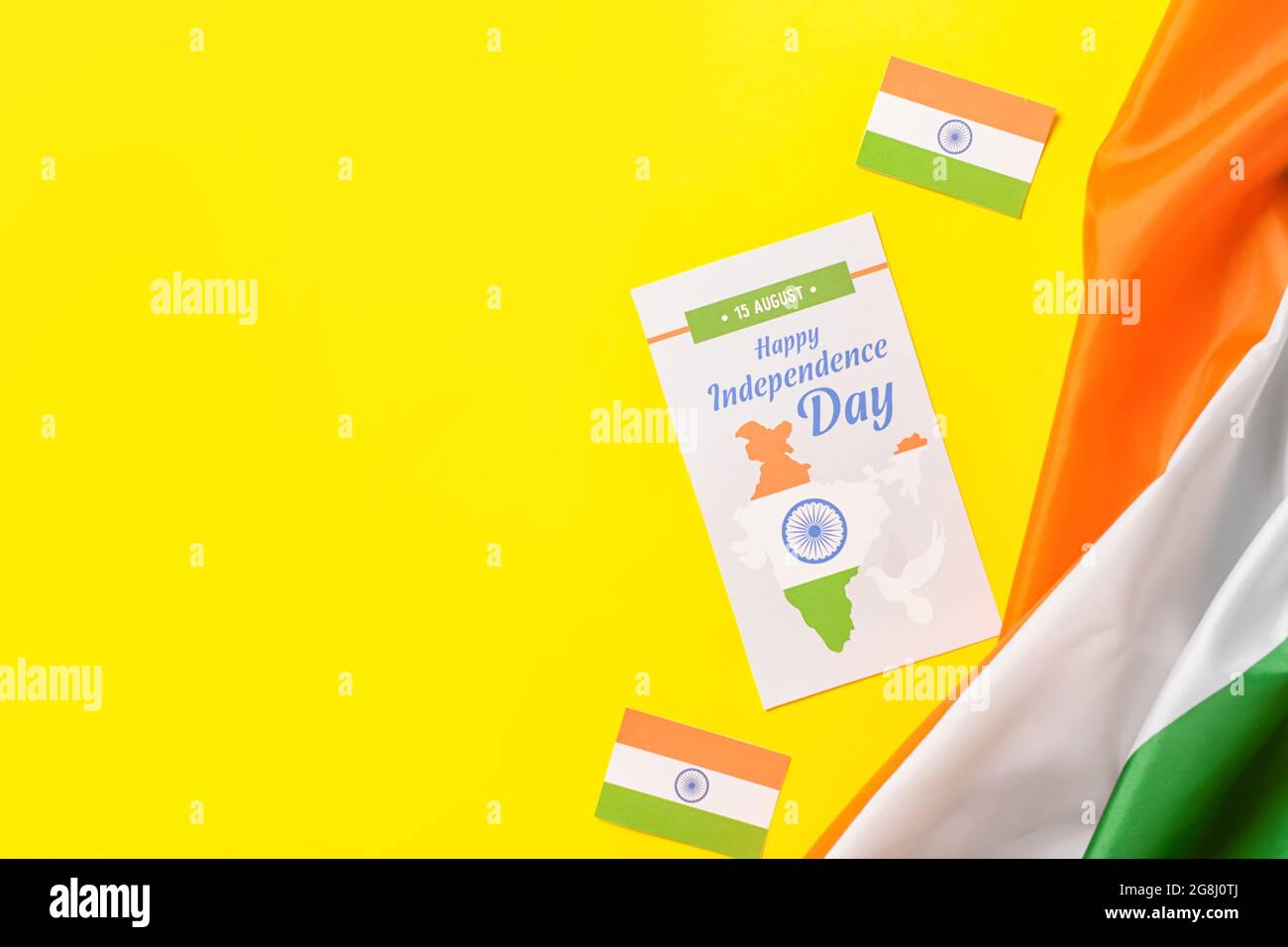 Indian flags and greeting card for Independence Day on color background ...