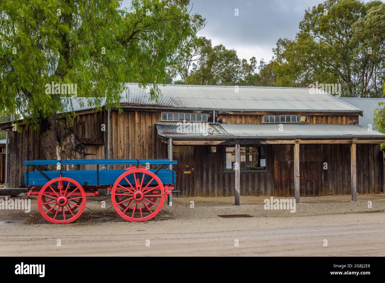 A single historic wagon stands on a dirt main street in  the old historic replica town of Echuca on the Murray River in Victoria, Australia. Stock Photo