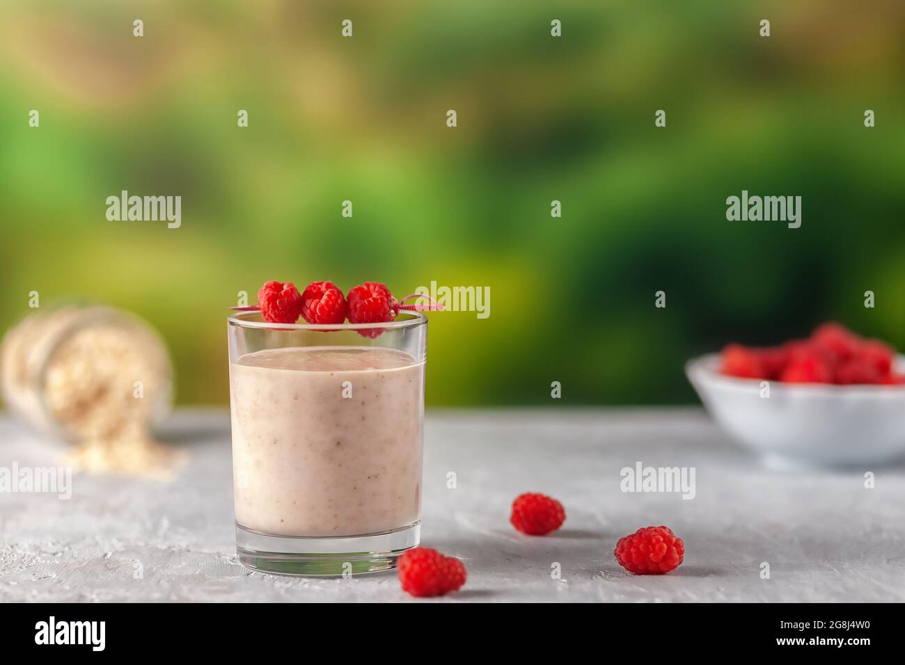 Oatmeal milkshake with bananas and raspberries. Healthy diet food Stock Photo