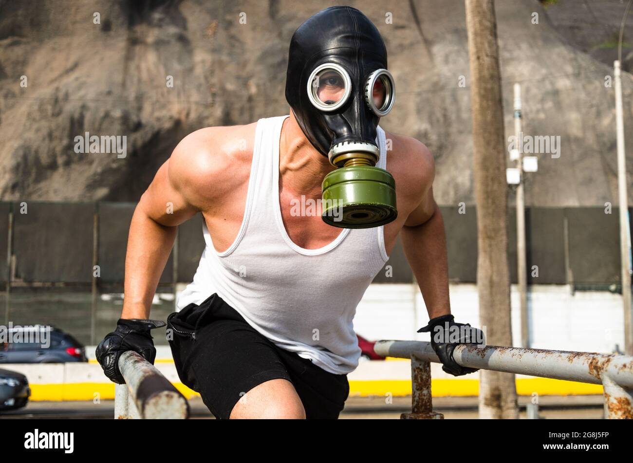 athletic man in a protective mask at practice in the morning. Stock Photo