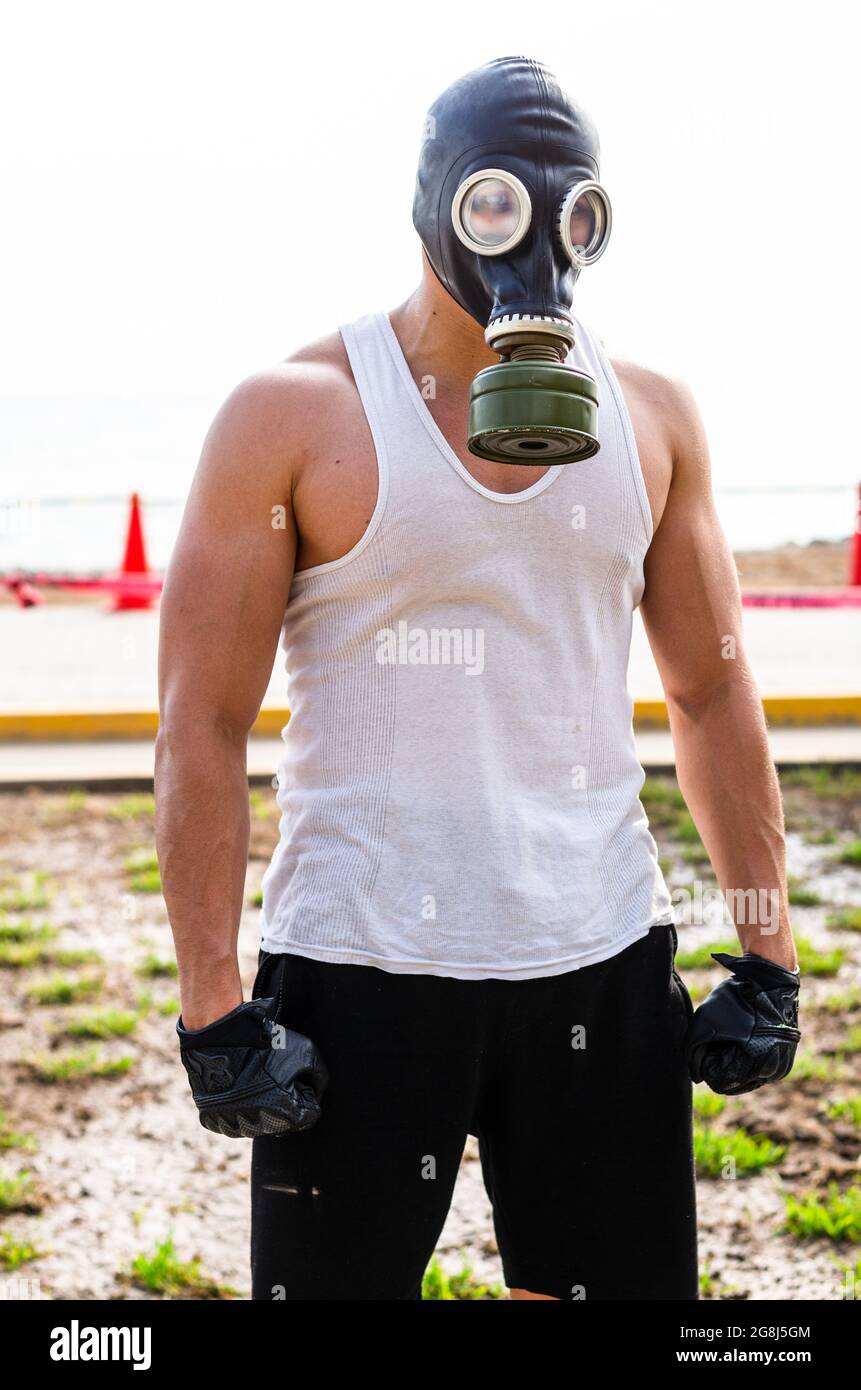 A muscular man in a gas mask. Pademic concept Stock Photo