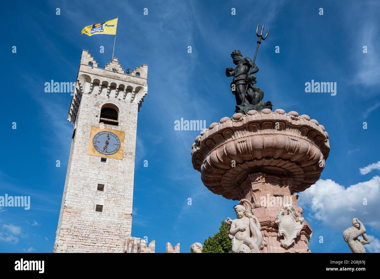 Trento, Italy, June 2021. Beautiful photo in the main square: detail of the fountain of Neptune with the civic tower in the background. Nice sunny day Stock Photo
