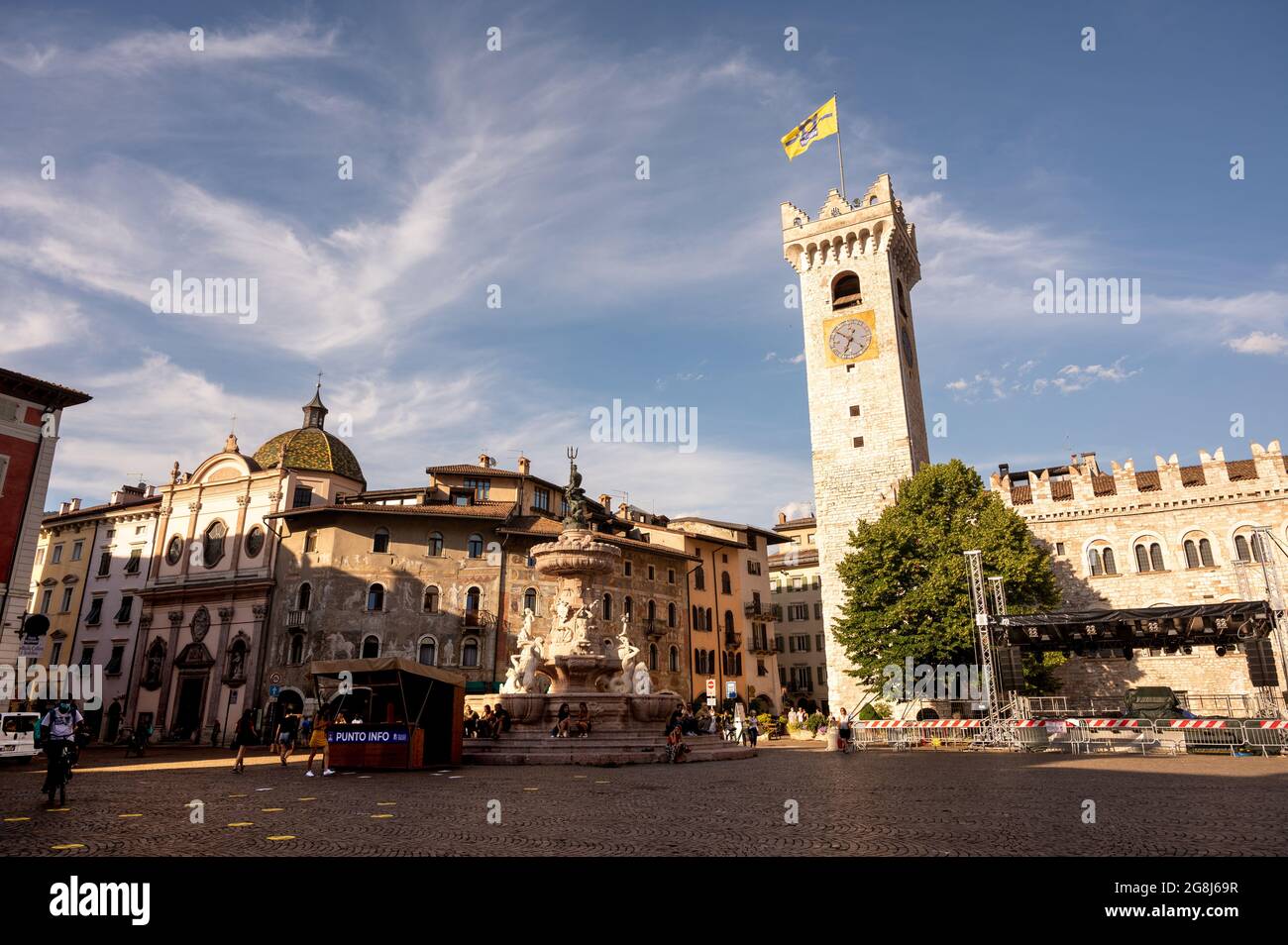 Trento, Italy, June 2021. Amazing photograph at the golden hour of the main square: in evidence the frescoed facade of the historic building, the bell Stock Photo