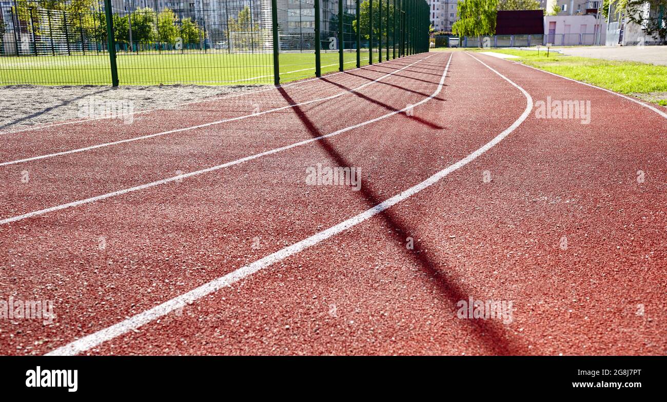 Red treadmill on sport field. Running track on the stadium Stock Photo Alamy
