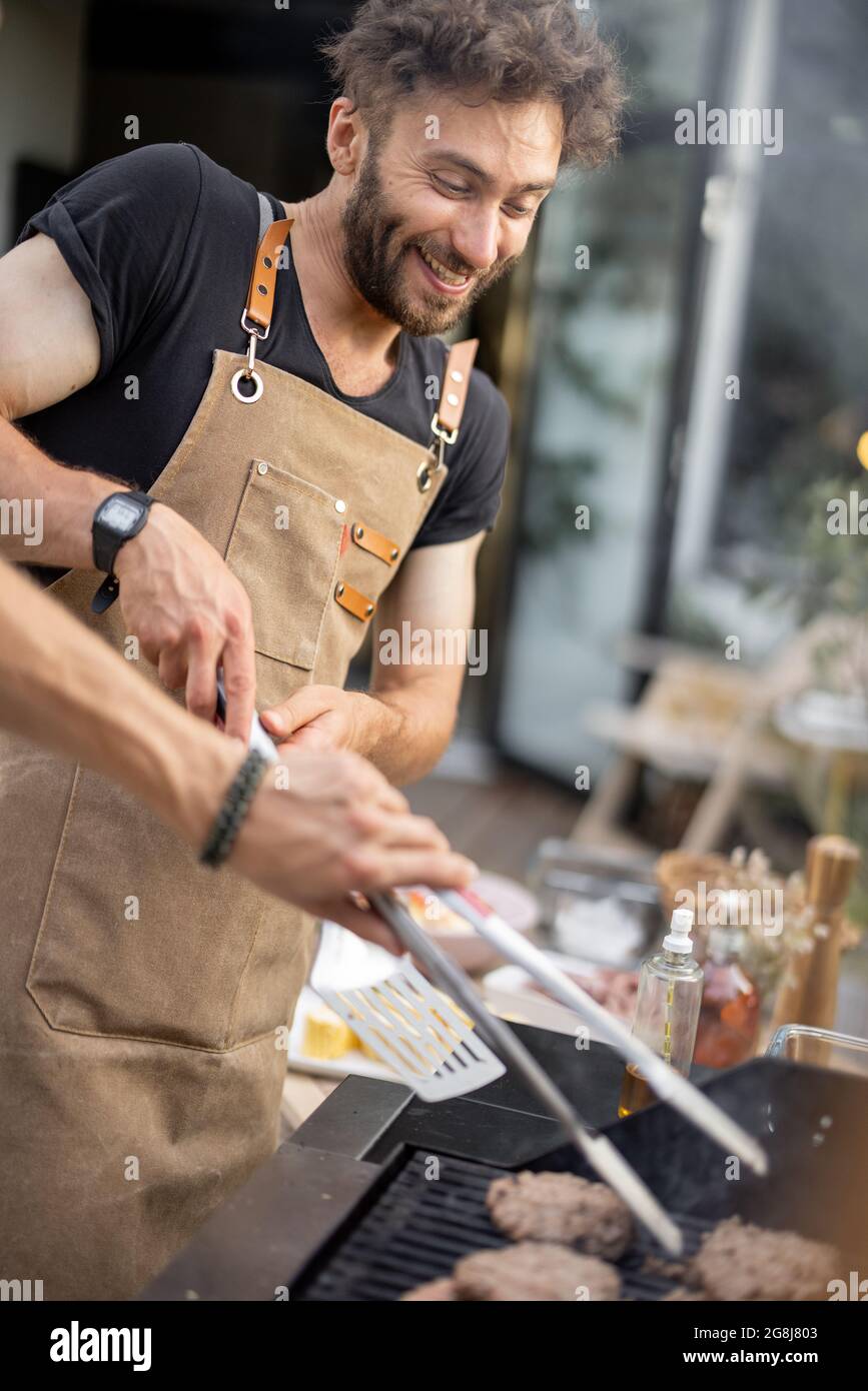 Funny guy grilling at backyard Stock Photo Alamy