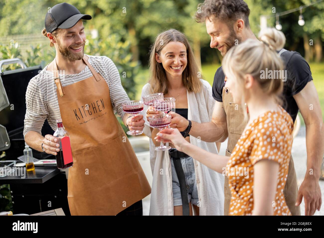 Friends celebrating with alcohol drinks outdoors Stock Photo