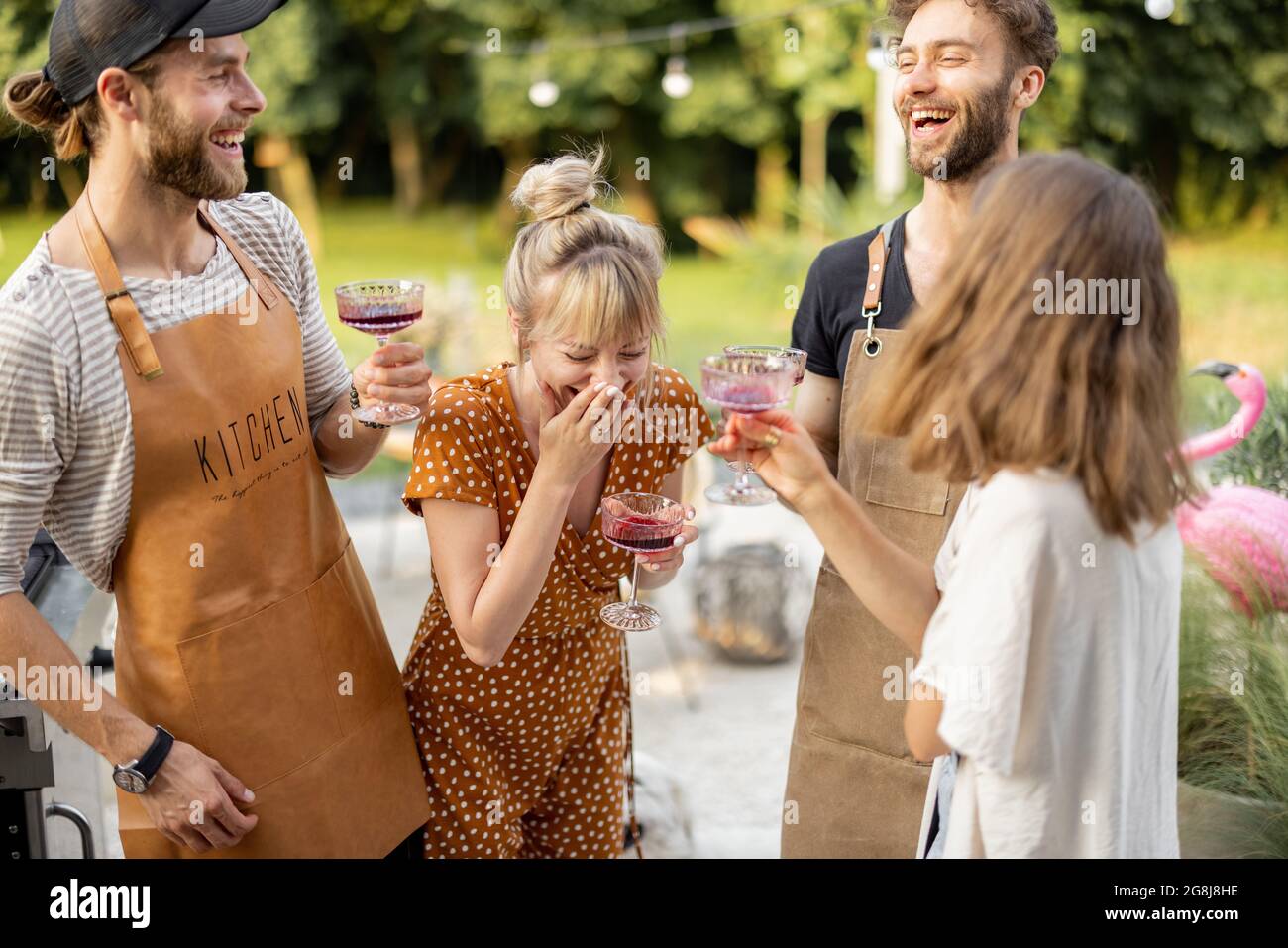 Friends celebrating with alcohol drinks outdoors Stock Photo