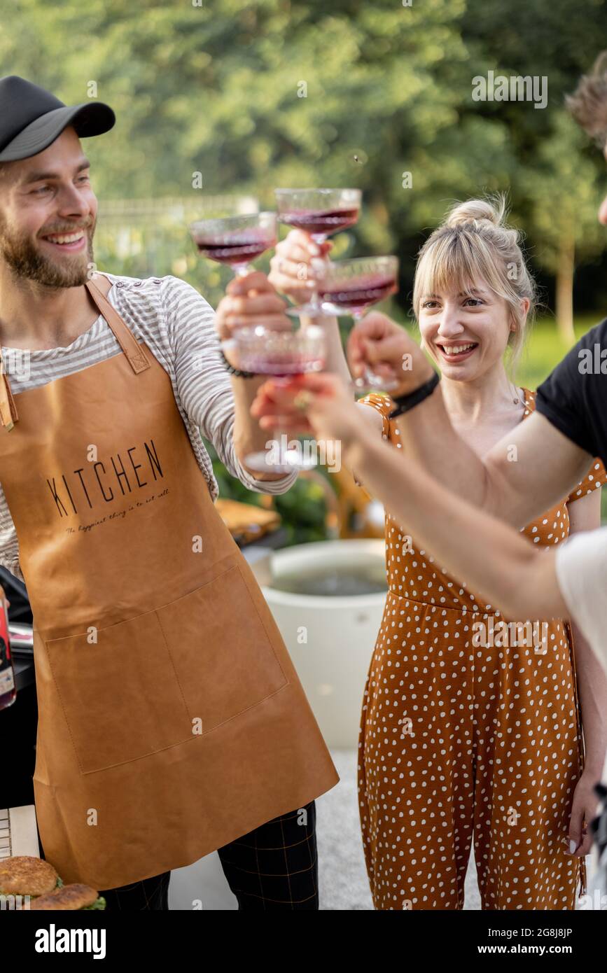 Friends celebrating with alcohol drinks outdoors Stock Photo