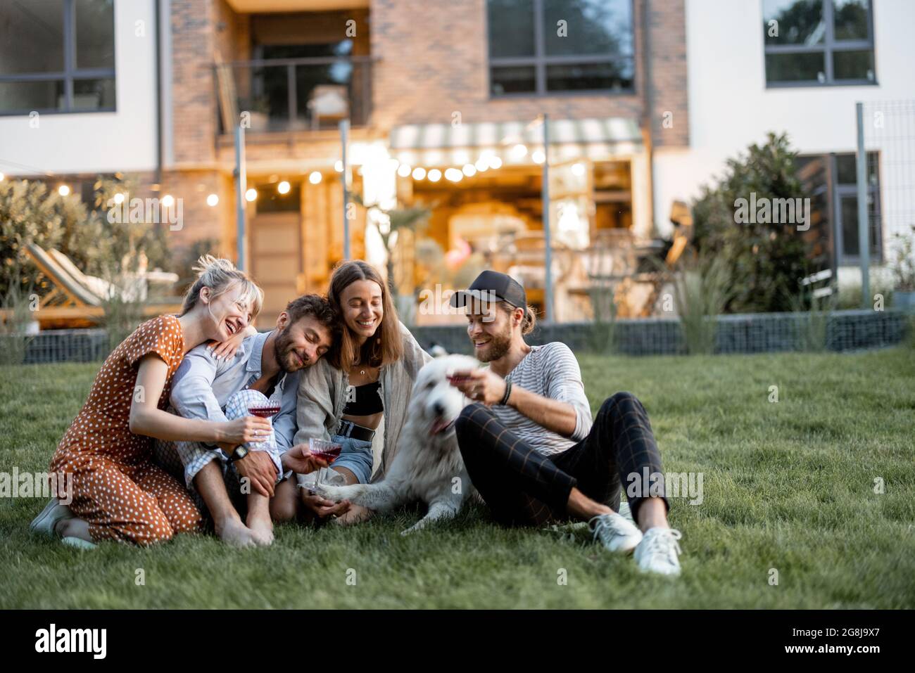 Friends having fun at backyard in the evening Stock Photo