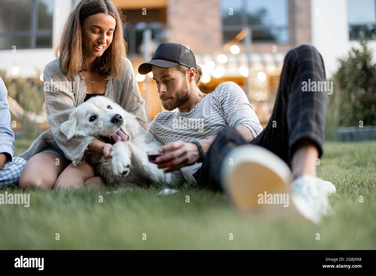 Friends having fun at backyard in the evening Stock Photo