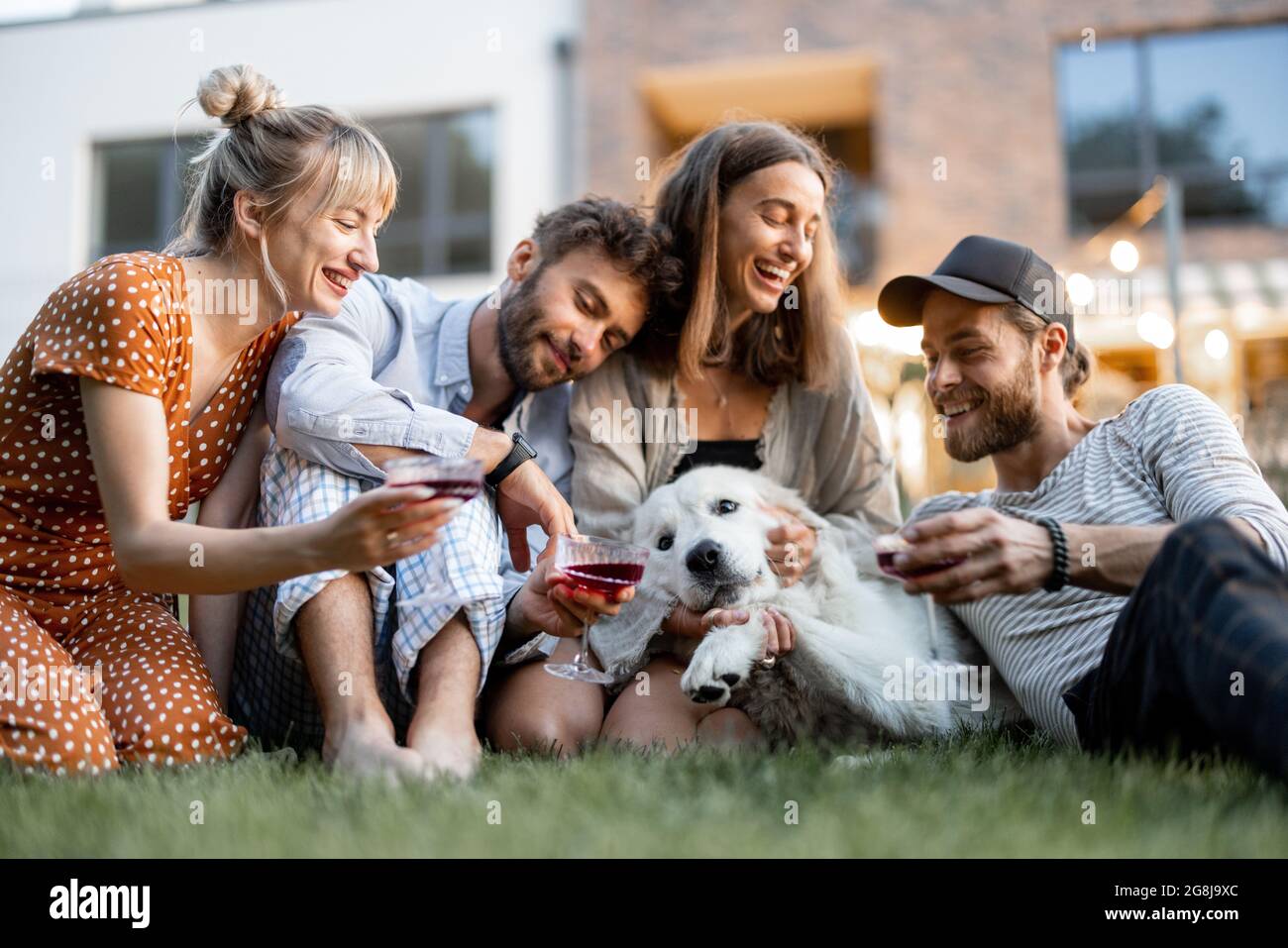 Friends having fun at backyard in the evening Stock Photo