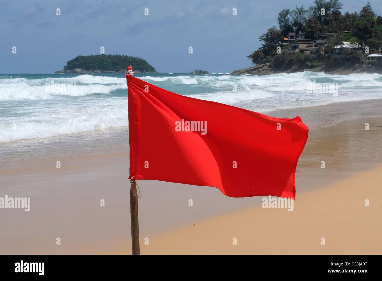 Red flags flying on Kata beach, Phuket Thailand Stock Photo