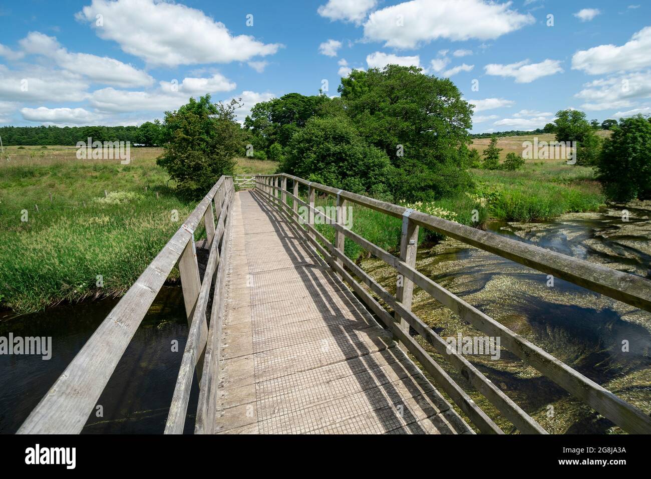 Wooden bridge over the River Lowther on the Lowther Loop of the Ullswater Way, between Whale and Helton, Cumbria Stock Photo