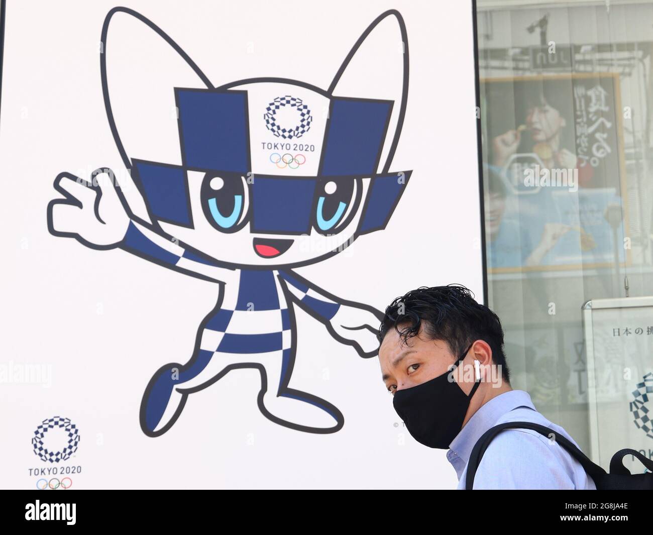 Tokyo Japan 21st July 21 A Man Walks By A Poster Depicting Miraitowa The Official Mascot Of The Summer Olympics In A Tokyo Street Tokyo Was To Host The Summer Tokyo Japan 21st July 21 A Man Walks By A Poster Depicting Miraitowa The Official Mascot Of The Summer Olympics In A Tokyo Street Tokyo Was To Host The Summer