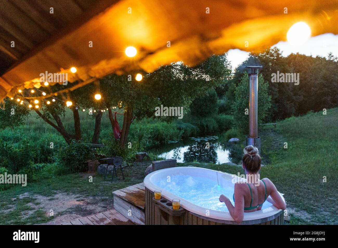 Woman enjoy outside ofuro japanese hot tub in romantic country