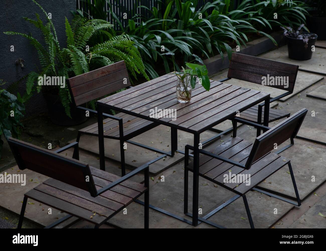 Wooden garden table set with 4 chairs made of wood with flowers in ...