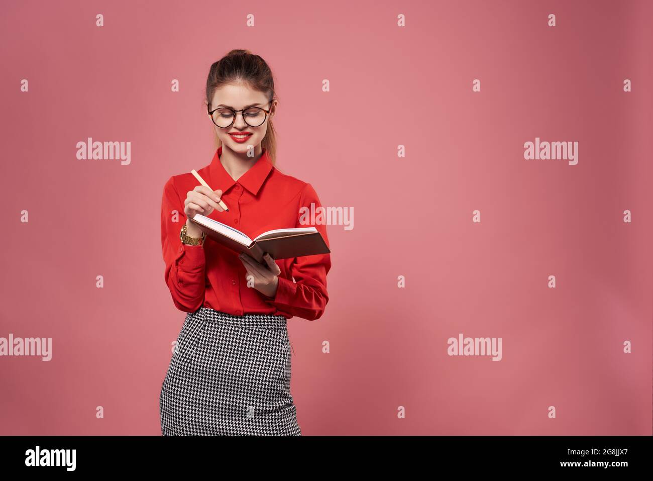 Business woman in red shirt with notepad in hands of work professionals ...