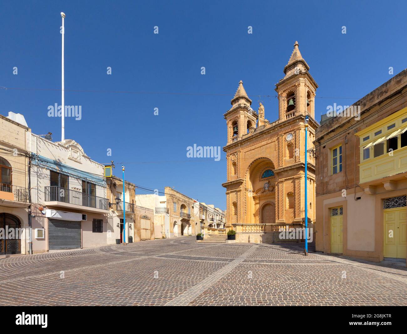 Facade and belfries of the old church of St. Peter on a sunny morning. Marsaxlokk. Malta. Stock Photo