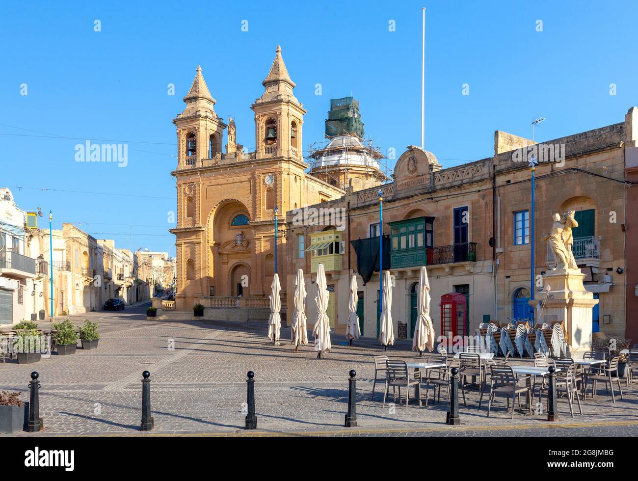 Facade and belfries of the old church of St. Peter on a sunny morning. Marsaxlokk. Malta. Stock Photo