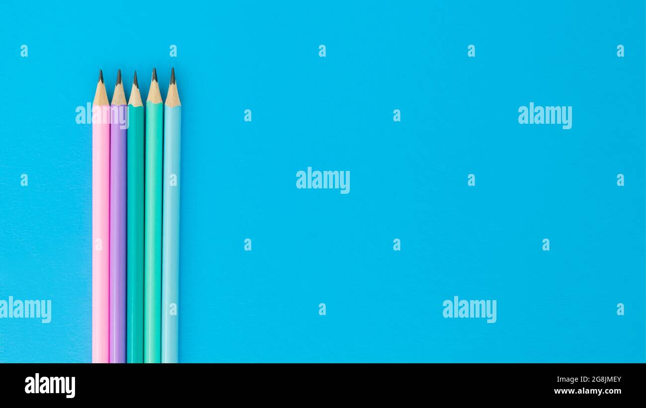 Some pencils on blue background with copyspace, top view Stock Photo
