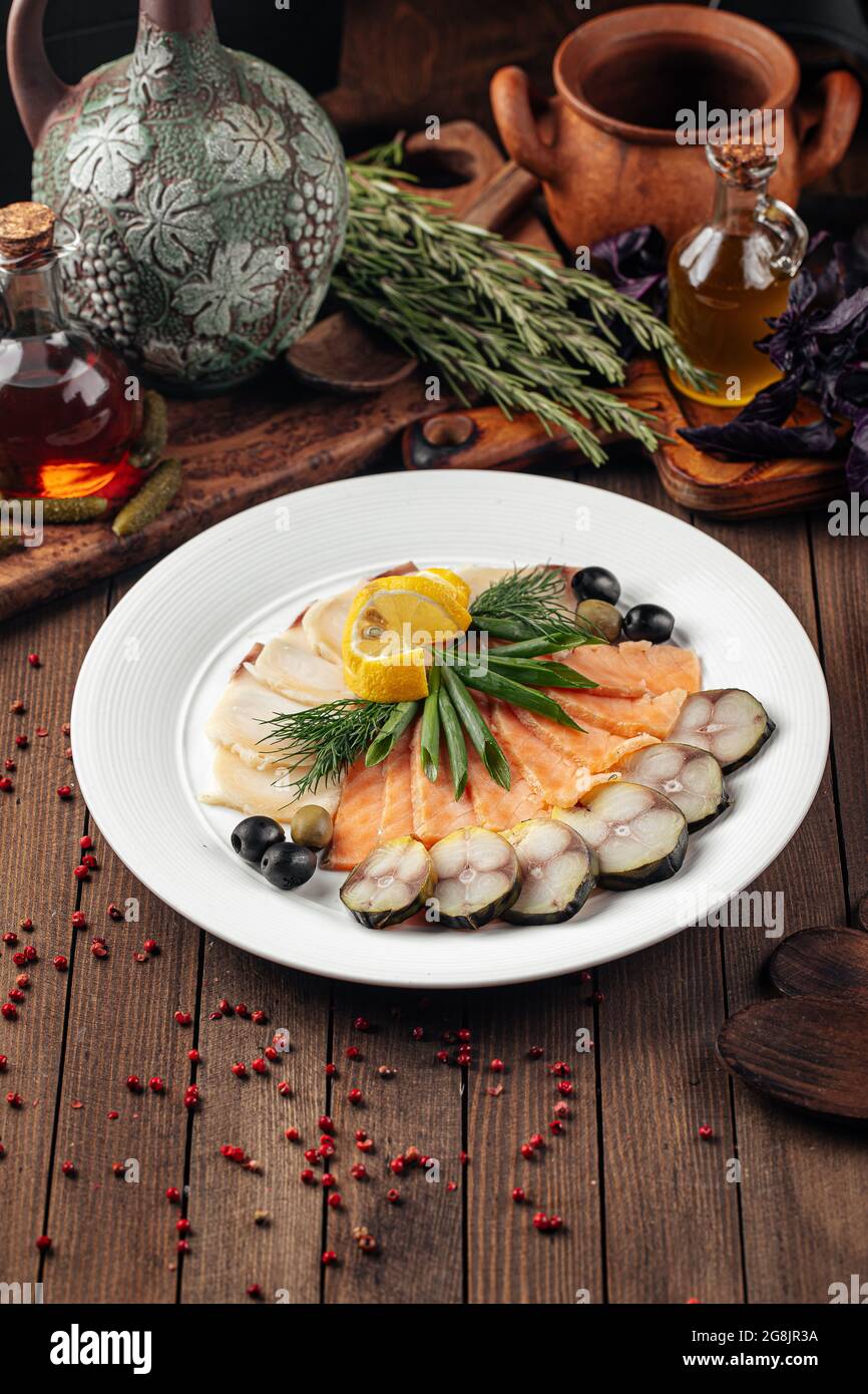 Assorted smoked fish platter on wooden background Stock Photo - Alamy