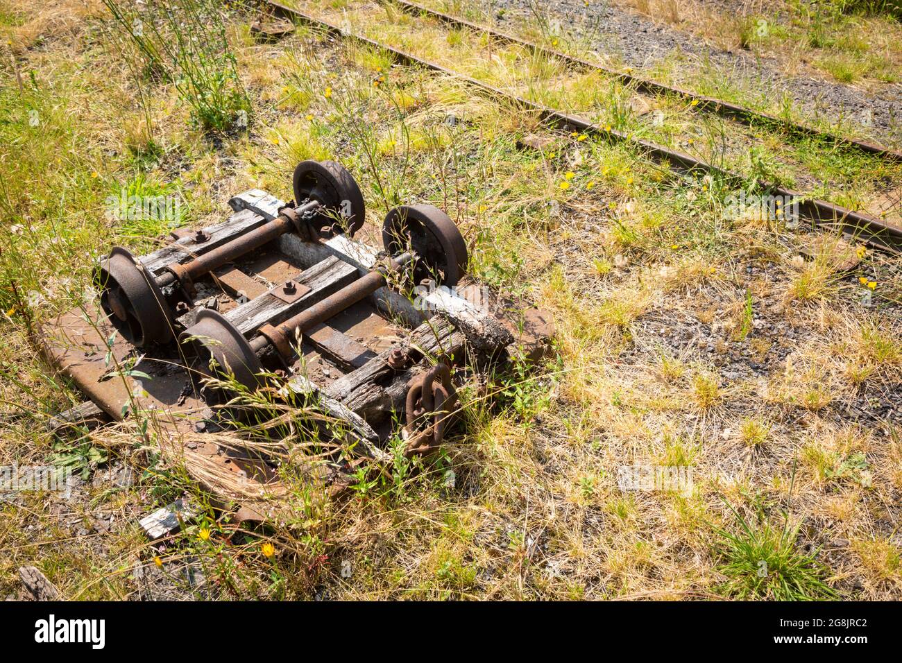 Old rusty industrial heritage rail bogie on wasteland, UK Stock Photo
