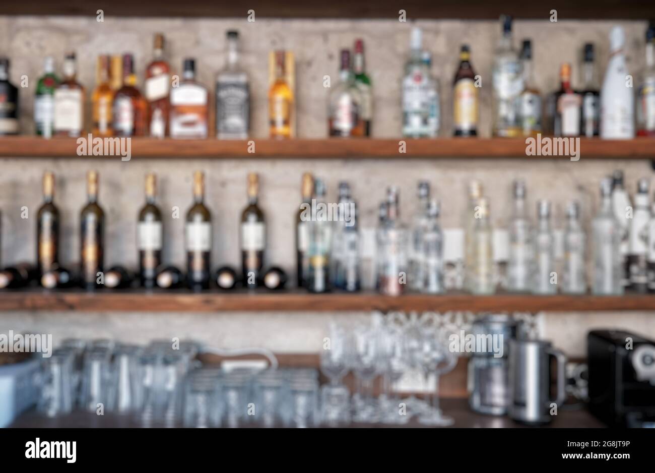 Liquor bar background with blurry alcohol drink bottles. Daylight