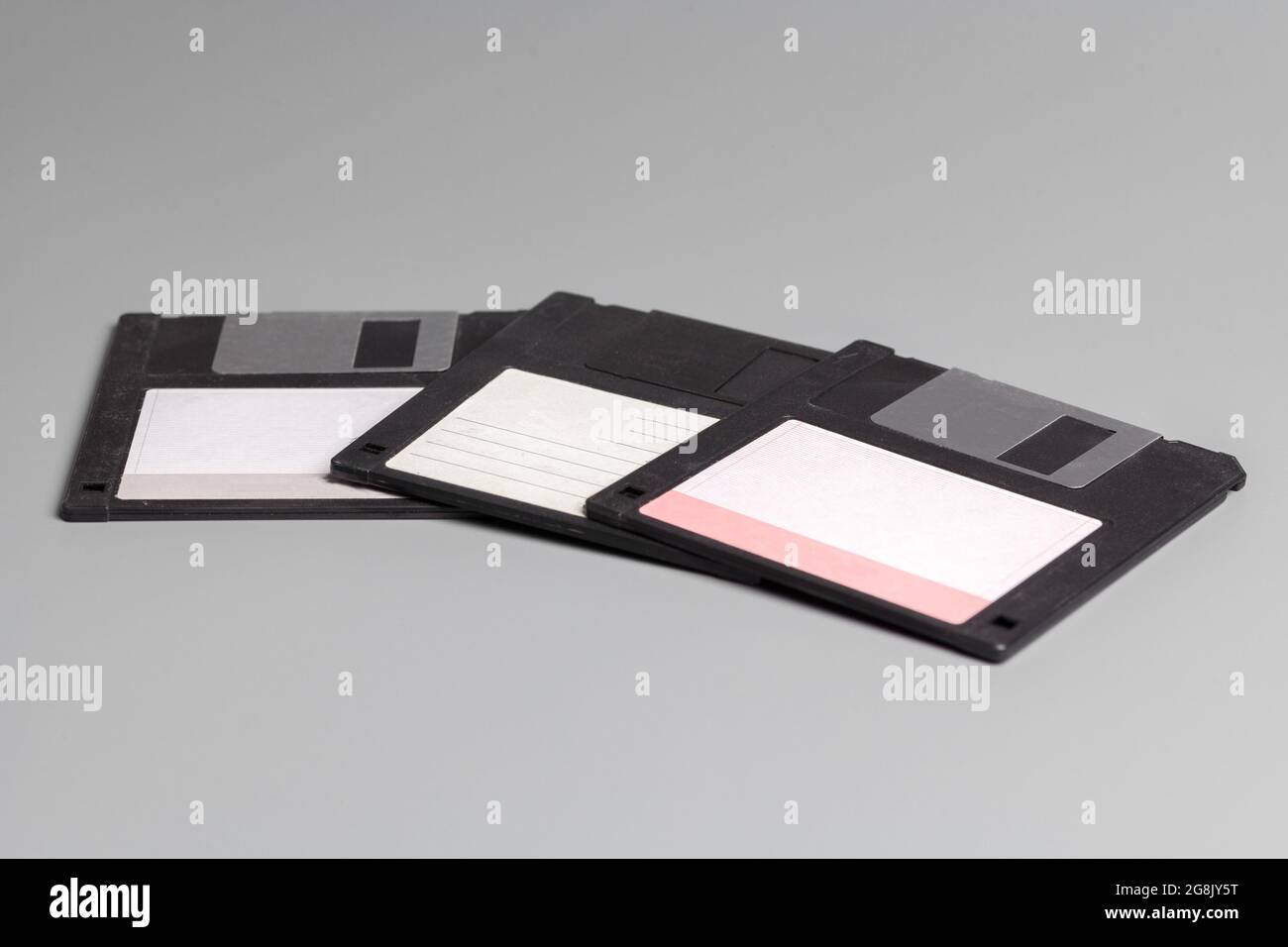 Three old computer diskette over grey background Stock Photo