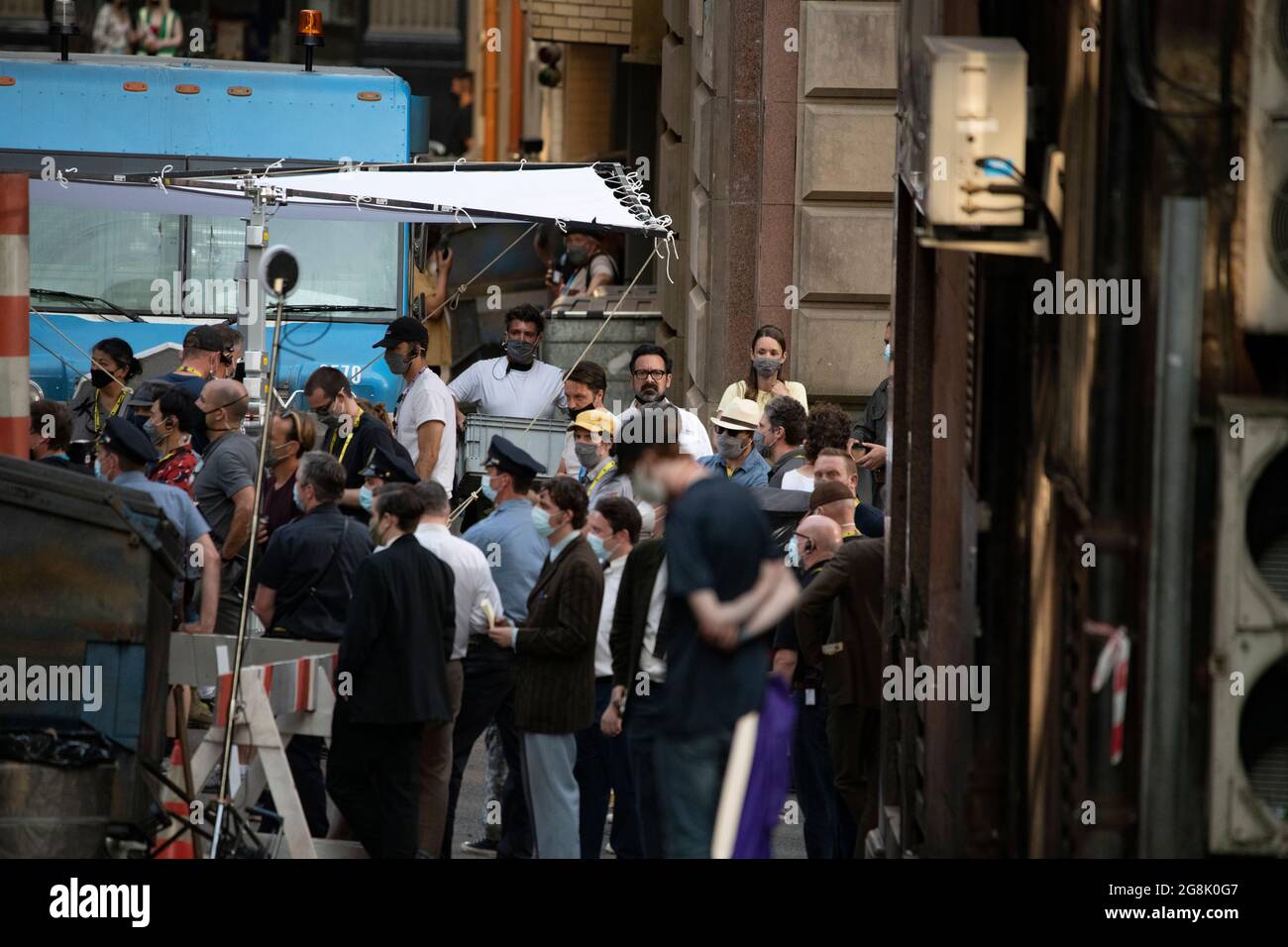 Glasgow, Scotland, UK. 20 July 2021.  PICTURED: Cast members seen in between takes on and off film set. Filming on the set of Indiana Jones 5 in the middle of Glasgow city centre as the Hollywood blockbuster sets up Glasgow as New York City. A full production can be seen, with a large cast, producers and extras. The city centre has been changed so that all the shop fronts and building look like 1959 America. Credit: Colin Fisher Stock Photo
