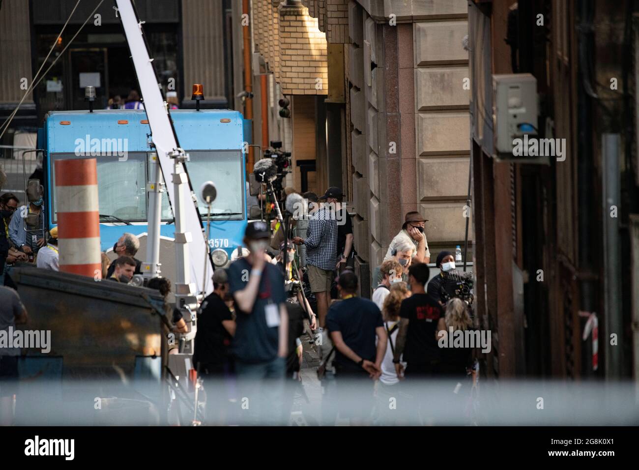 Glasgow, Scotland, UK. 20 July 2021.  PICTURED: Cast members seen in between takes on and off film set. Filming on the set of Indiana Jones 5 in the middle of Glasgow city centre as the Hollywood blockbuster sets up Glasgow as New York City. A full production can be seen, with a large cast, producers and extras. The city centre has been changed so that all the shop fronts and building look like 1959 America. Credit: Colin Fisher Stock Photo