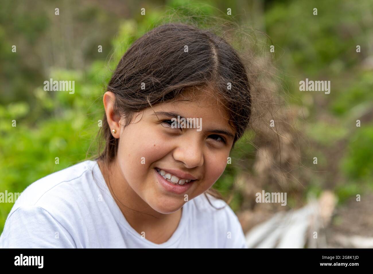portrait of a tousled latina girl smiling looking at the camera Stock Photo