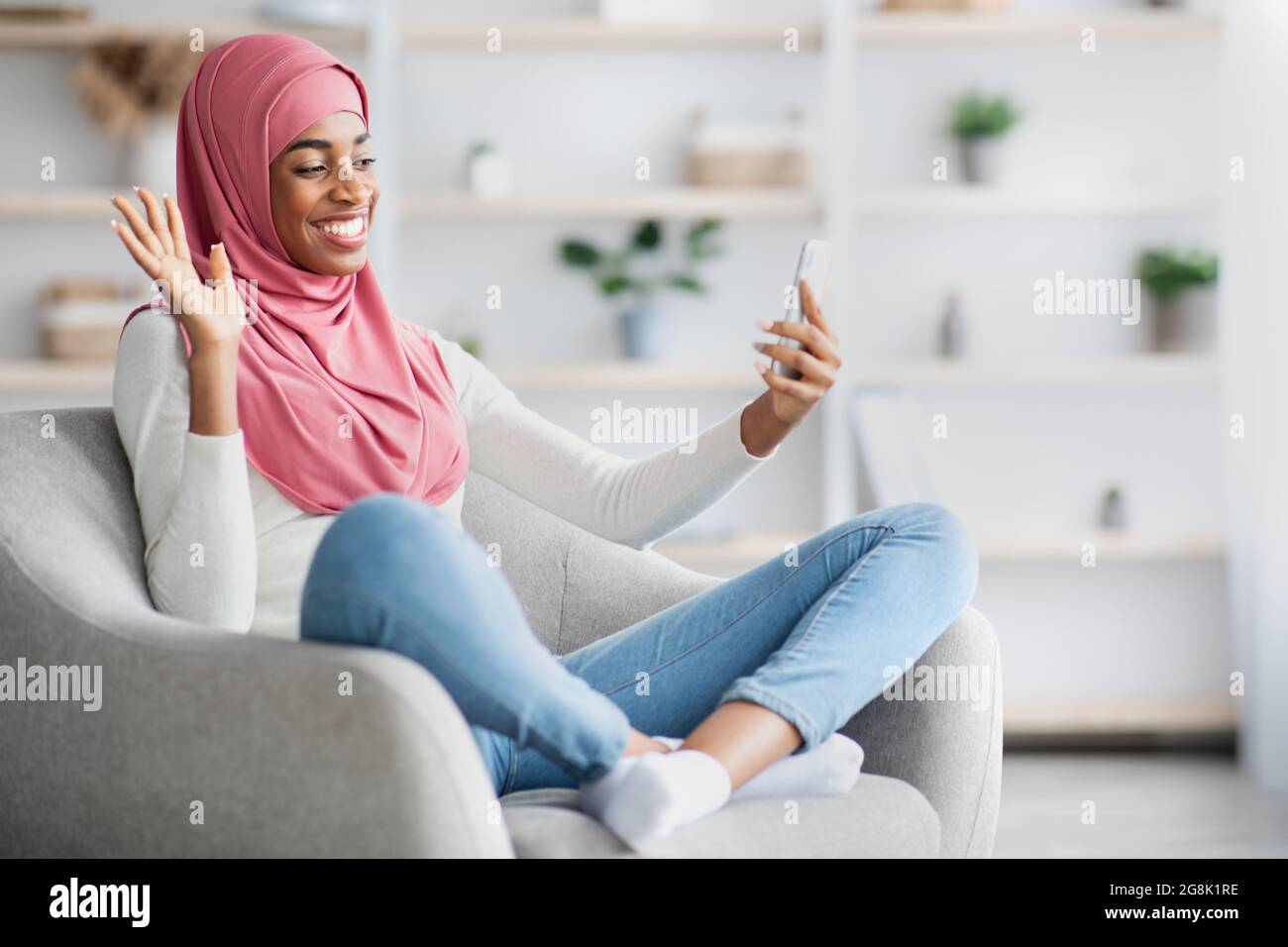 Black Muslim Lady In Hijab Making Video Call With Smartphone At Home ...