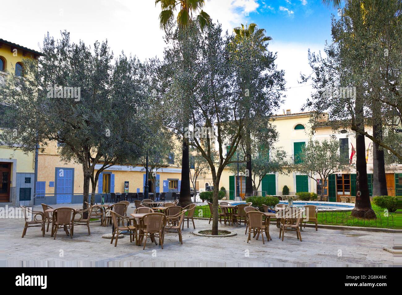 Idyllic square with a water fountain in the town of Petra in the evening, central Majorca or Mallorca, Balearic Islands, Mediterranean Sea. Stock Photo