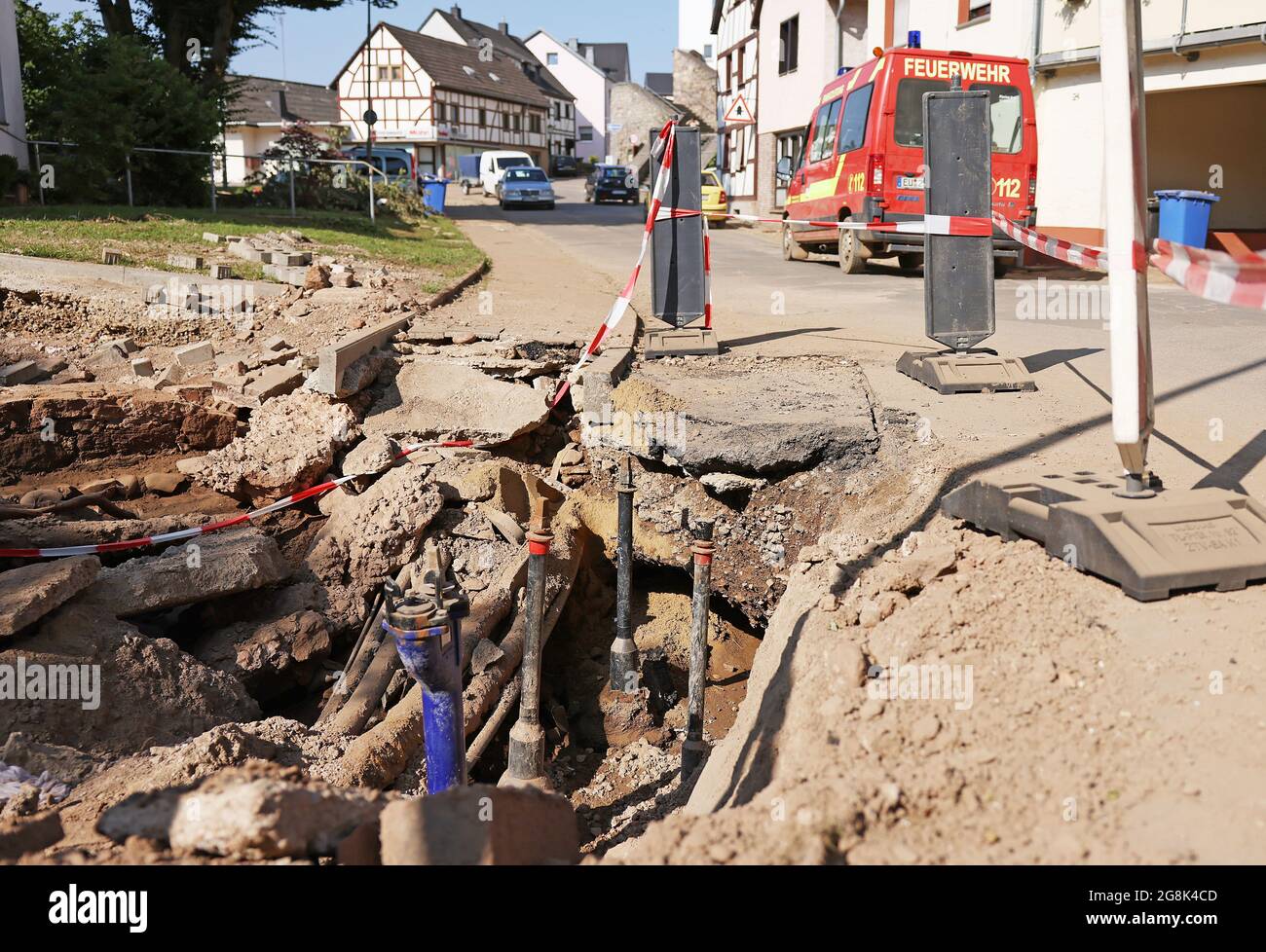Kall, Germany. 21st July, 2021. A fire engine drives past exposed cables and lines. After the floods in the Eifel, the damage to the infrastructure is surveyed. Credit: Oliver Berg/dpa/Alamy Live News Stock Photo