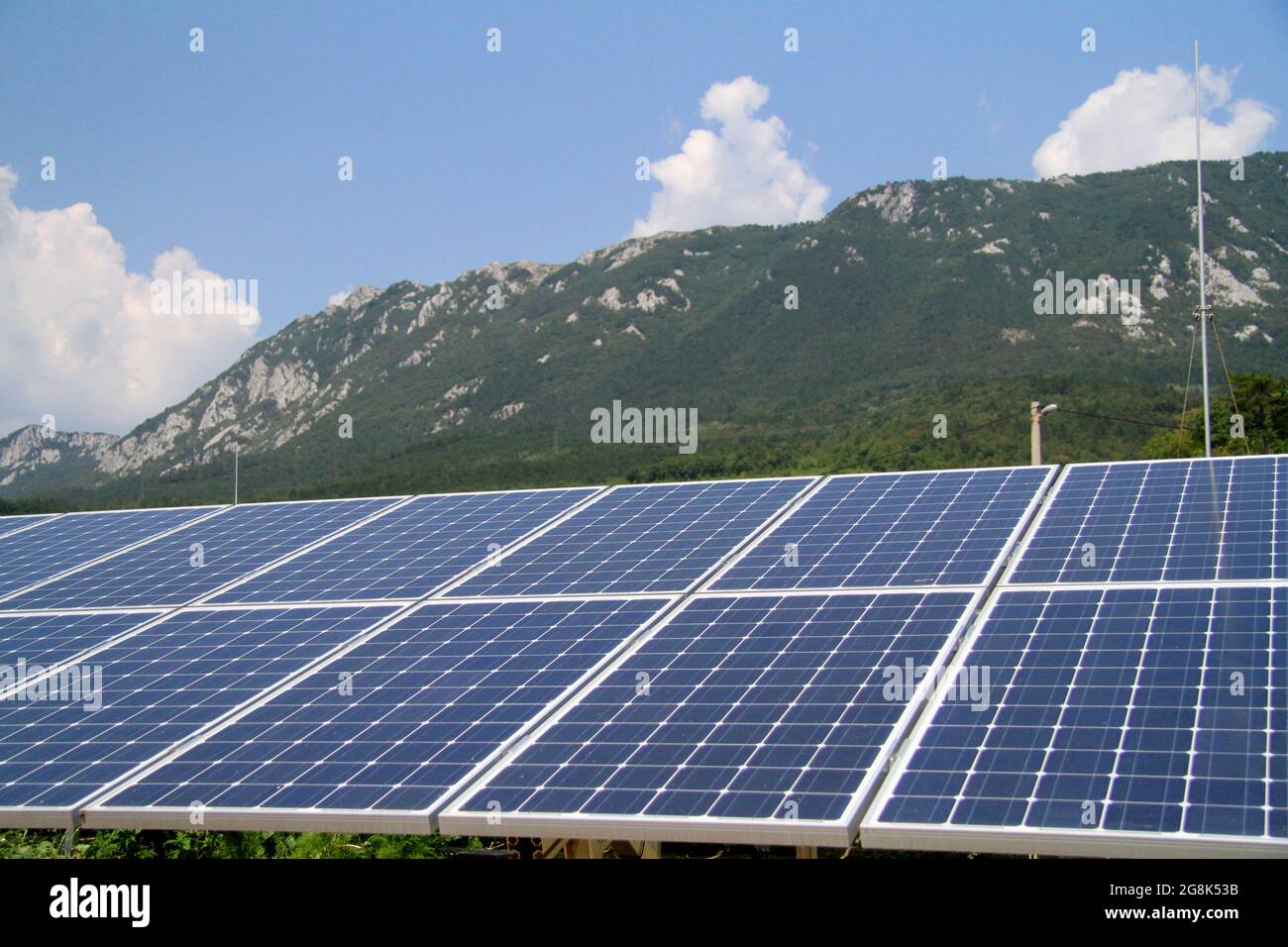 Rows of blue solar panels on a roof under a bright sky Stock Photo - Alamy
