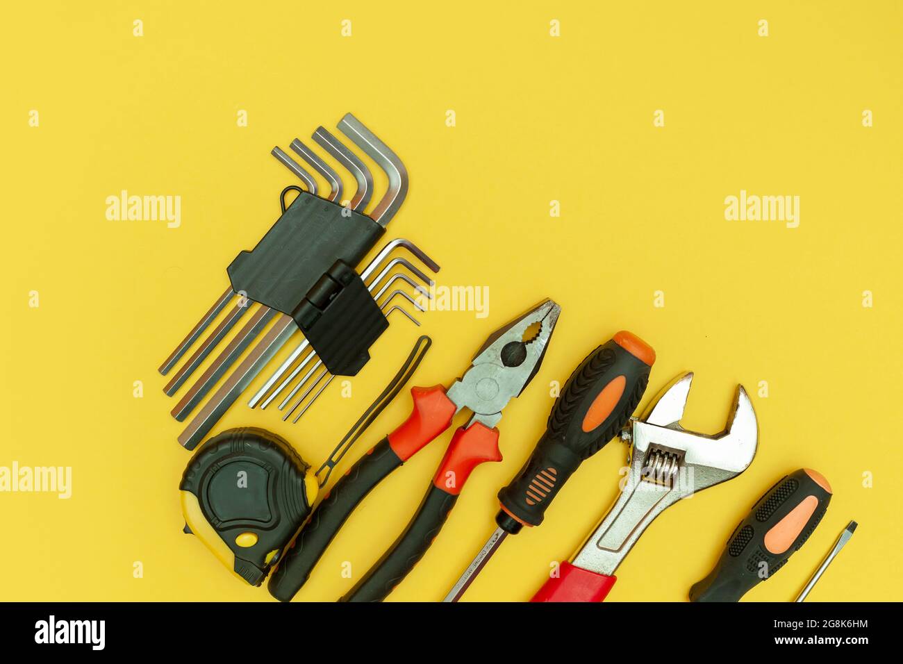 tools on isolated yellow background Stock Photo - Alamy