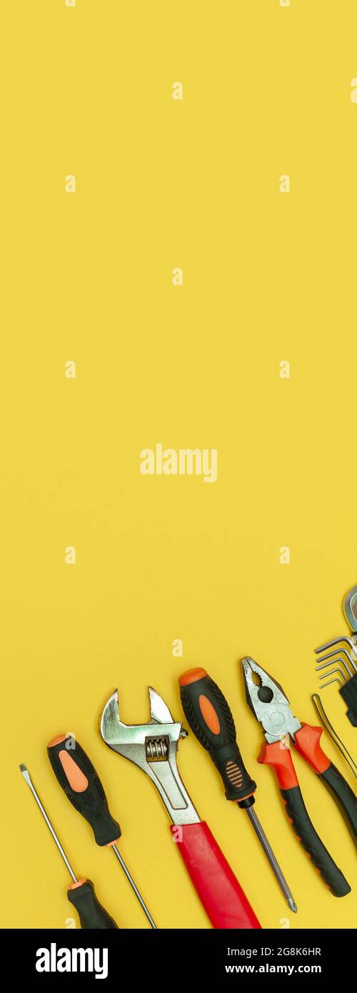 tools on isolated yellow background panorama Stock Photo - Alamy