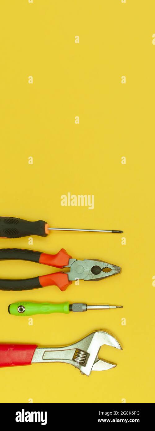 tools on isolated yellow background panorama Stock Photo - Alamy