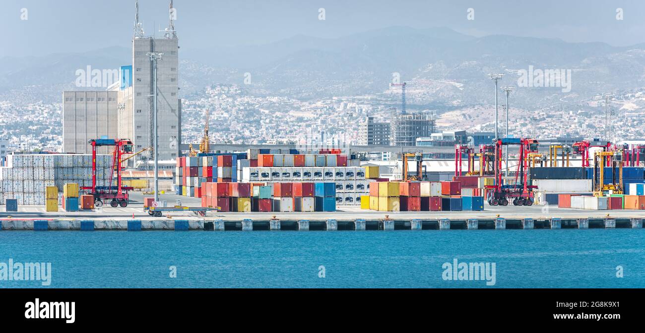 Container yard with straddle carriers and other facilities in cargo terminal of Limassol port, Cyprus Stock Photo